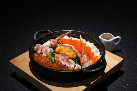 japanese cuisine. Sashimi on hot pot over black background