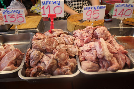 Raw chicken meat for sale at a local market in Bangkok, Thailandの写真素材