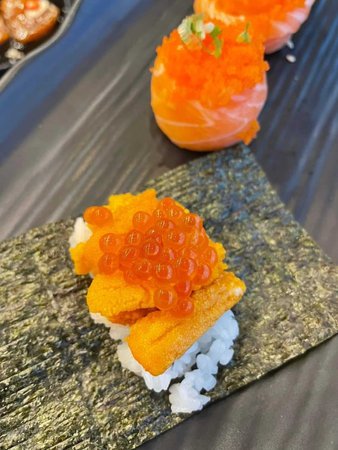 Sushi with salmon, shrimp and caviar on a black backgroundの写真素材