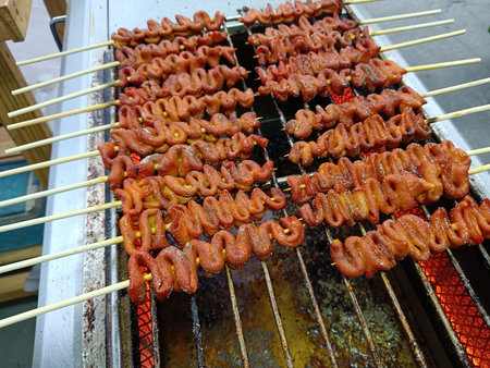 Grilled sausage on the grill in the street market.の写真素材