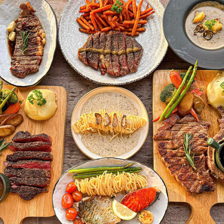 Collage of different kinds of grilled meat and vegetables on wooden board