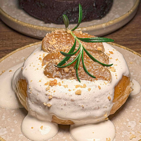Cake with rosemary on a wooden background. Toned.