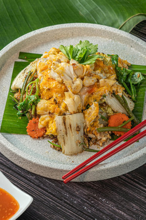 Stir fried rice noodle with pork and egg on wooden tableの写真素材