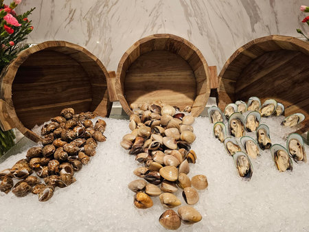 Fresh mussels in wooden barrels on ice in a restaurant, closeup