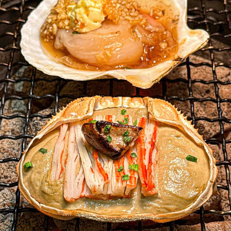 Japanese cuisine, grilled fish and vegetables served on a hot charcoal grillの写真素材