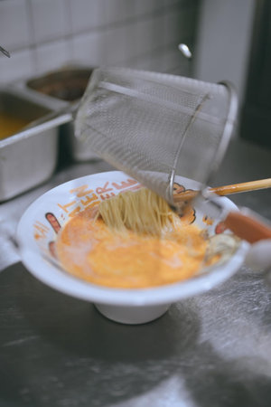 Cooking spaghetti in a restaurant kitchen. Shallow depth of field.