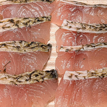 Slices of tuna fish on a wooden board. Toned.
