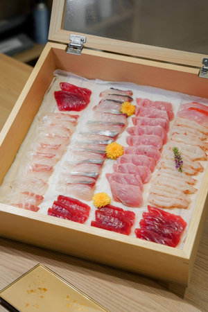 Sashimi set in a wooden box, closeup of photo