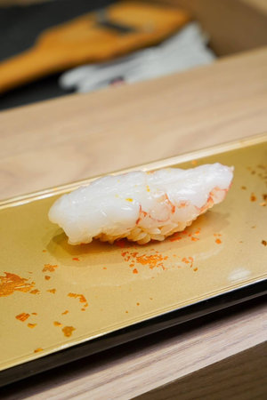 Shrimp Tempura Sushi on a golden plateの写真素材