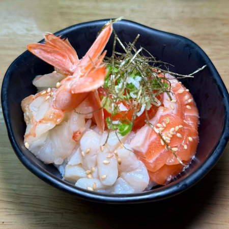 japanese food salmon sashimi in black bowl on wooden tableの写真素材