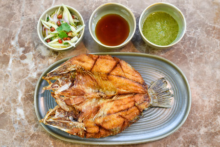 Fried fish with spicy sauce,Thai food style on ceramic plate