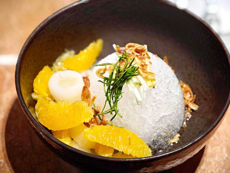 Sashimi with orange and dill in a bowl on the tableの写真素材