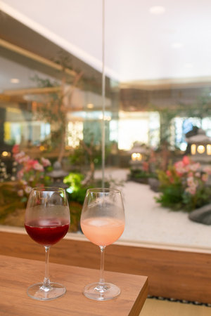 Two glasses of wine on a table in a restaurant, blurred backgroundの写真素材