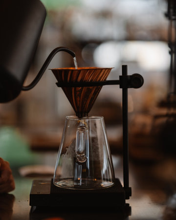 Coffee brewing process. Coffee grinder in a coffee shop