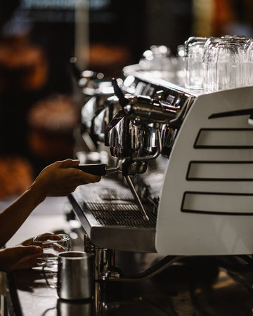 Close-up of barista making coffee in coffee shop. Selective focus.の写真素材