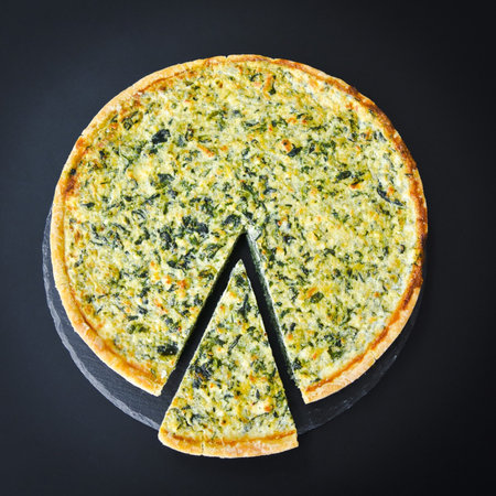 Pizza with spinach and cheese on a black background, top viewの写真素材