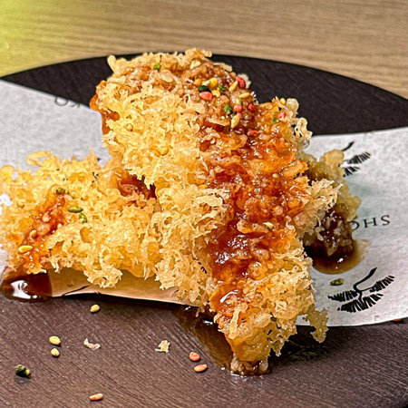 Baklava with honey and nuts on a black plate.の写真素材