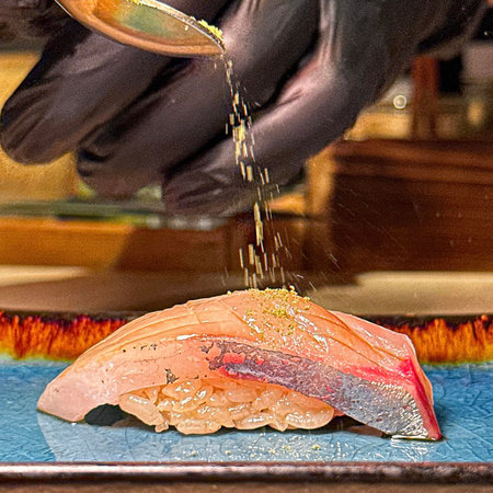 Japanese food. Sushi on a plate. Hand of chef preparing sushiの写真素材