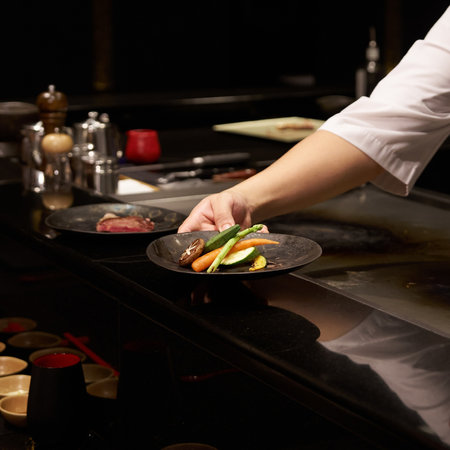 Chef preparing a dish in a restaurant kitchen, close-upの写真素材