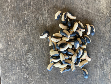 Dried black eyed peas on old wooden background. Top view.
