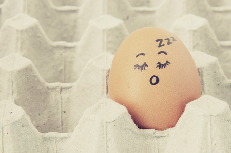 sleep face Eggs  arranged in cartonの写真素材