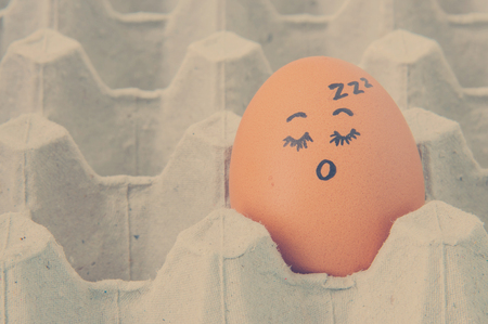 sleep face Eggs  arranged in cartonの写真素材
