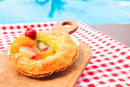 Picnic with Fruit pie and fruit jam on pool backgroundの写真素材