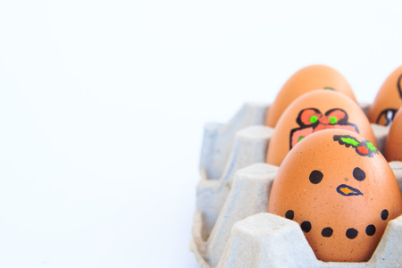 Christmas egg with faces drawn arranged in carton