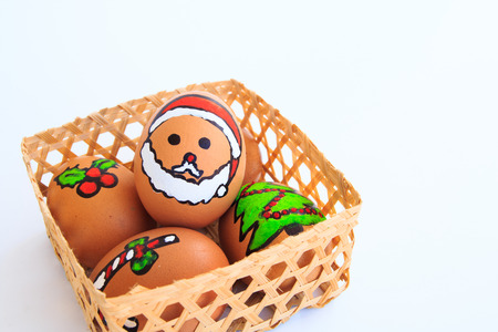 Christmas egg with faces drawn arranged in cartonの写真素材