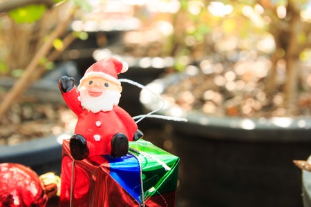 santa doll in forest ,gift box,Christmas baublesの写真素材