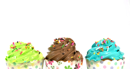 colorful cupcakes with colorful candy on white backgroundの写真素材