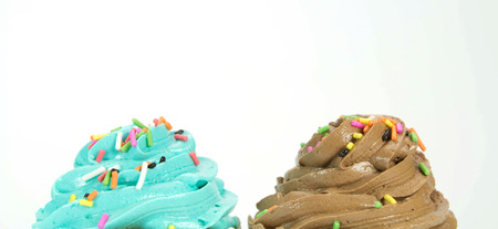 colorful cupcakes with colorful candy on white backgroundの写真素材