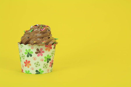 Chocolate Cupcake with creamy chocolate frosting on yellow backgroundの写真素材