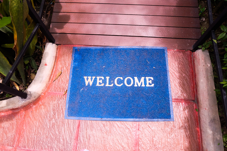 Blue Welcome carpet on floor.の写真素材