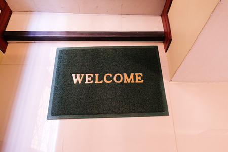 green welcome carpet on floor.の写真素材
