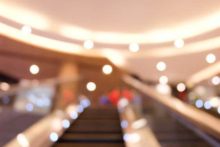 Abstract Blurred bokeh background with people in shopping mall with bokeh.