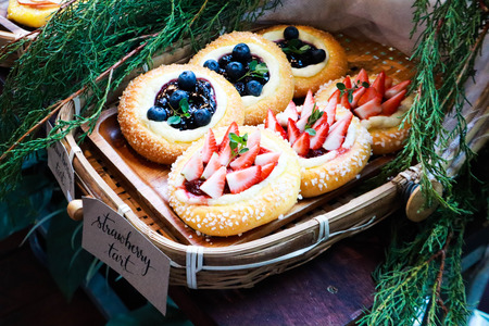 Delicious strawberries tart and blueberry tart in the bakery.