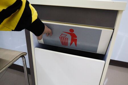 A women throwing garbage into recycle bin,waste bin at supermaket.の写真素材