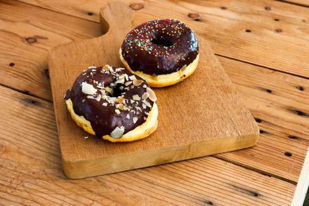 Glazed donuts on wooden tray.Concept of delicious fresh donuts.の写真素材