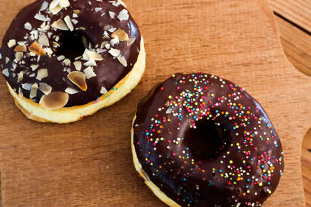 Glazed donuts on wooden tray.Concept of delicious fresh donuts.の写真素材