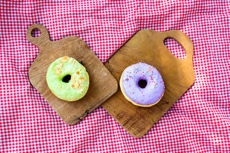 Picnic concept,Glazed donuts on wooden tray in garden.の写真素材