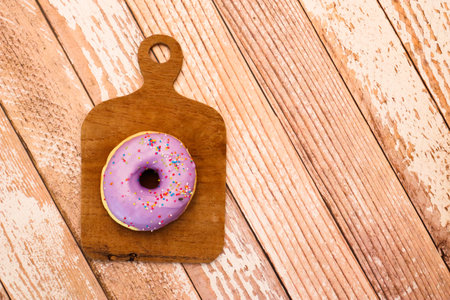 Glazed donuts on wooden tray.Concept of delicious fresh donuts.の写真素材