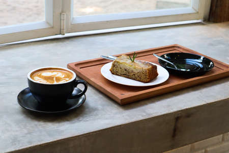 20 May 2020; Bangkok Thailand :coffee cup with cake on table in cafe.の写真素材