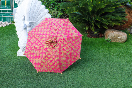Chiangmai - THAILAND , December 1,2021 : Colorful handmade  umbrella on grass, at Chiangmai ,lanna style.の写真素材
