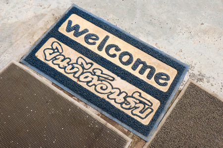 Blue Welcome doormat on floor.の写真素材