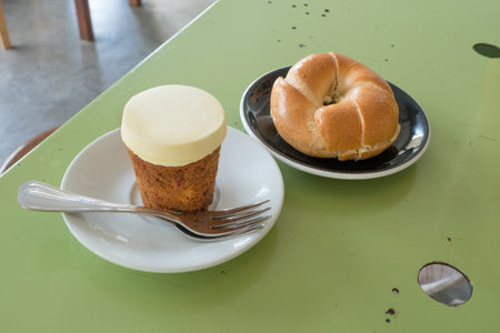 Delicious Bagel cream cheese and Carrot cake on table, Korean cafe.の写真素材