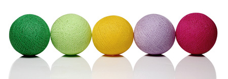 colorful cotton balls isolated on whiteの写真素材