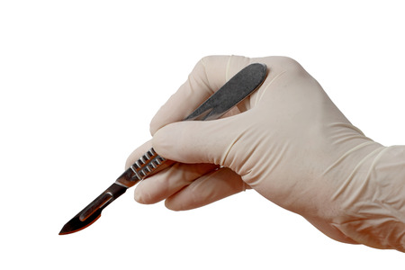 Hand in glove holding scalpel. Isolated on whiteの写真素材