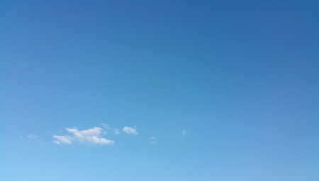 Clear blue sky with white cloudsの写真素材