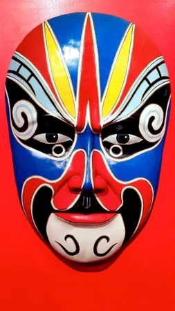 Chinese Traditional Opera Mask on red backgroundの写真素材